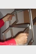 Concertina Loft Ladder featuring rigid sides which act as full length handrails