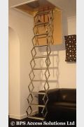 Concertina Loft Ladder shown pushed back therefore allowing more space in hatch for offering up larger items